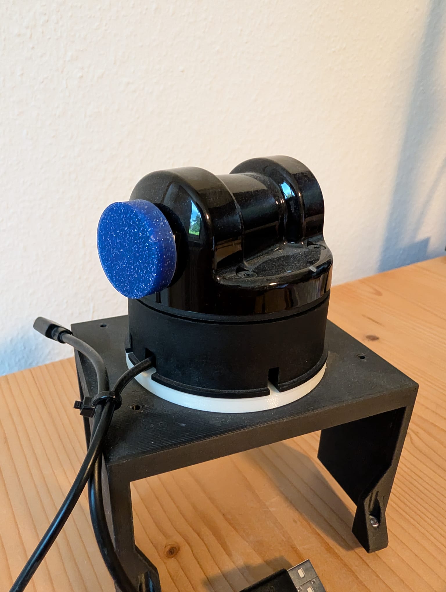 Unitree L1 LiDAR on a test stand with a blue 3D-printed counterweight on the spinning rotor assembly