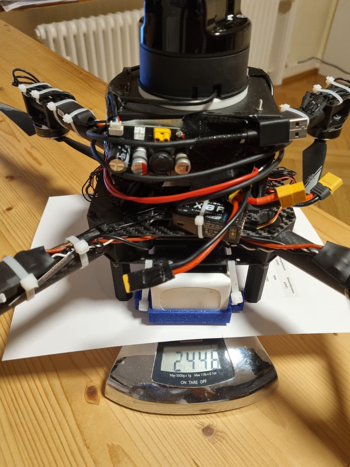 Upgraded drone with Unitree L1 LiDAR, Jetson stack, and custom power PCB on a scale reading 2448 g